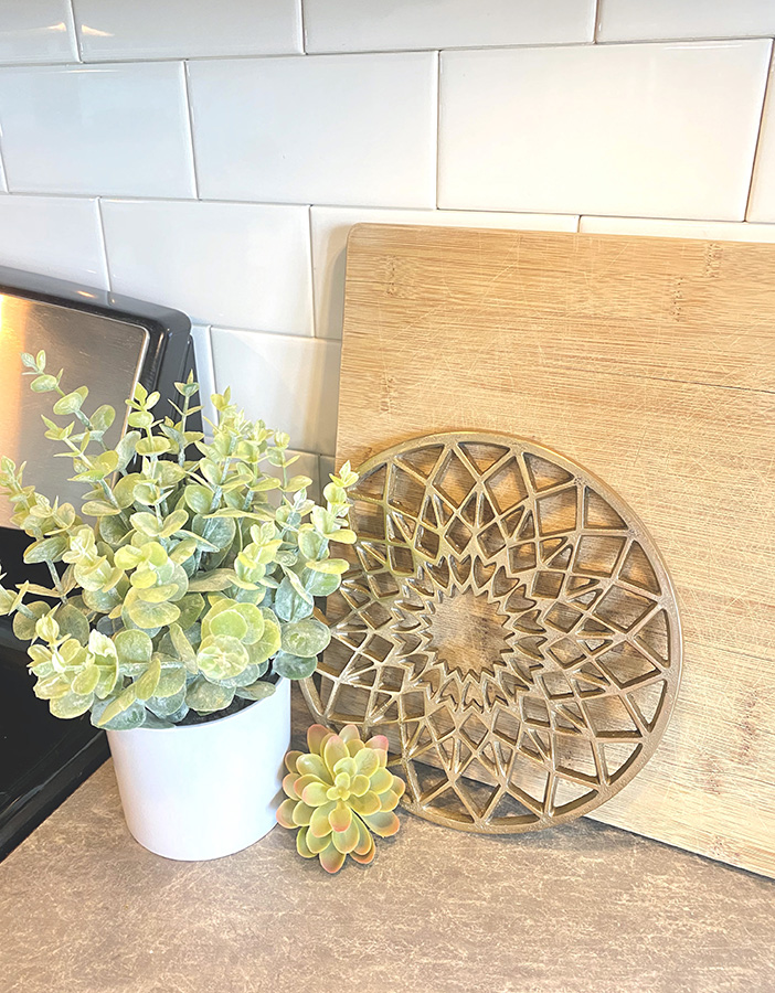 plant, cutting board, brass in kitchen